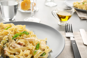 Delicious pasta alfredo with chicken on plate, closeup