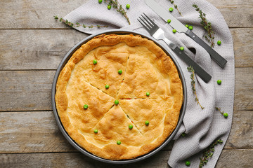 Baked chicken pot pie on wooden table