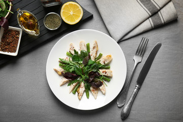Delicious dinner with chicken, arugula, spinach and basil on plate