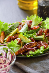 Salad with Teriyaki shrimps, avocado, lettuce and fried young corn. Close-up, selective focus.
