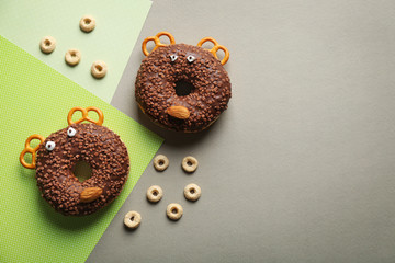 Funny decorated donuts on table