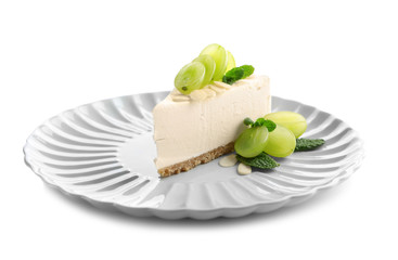 Plate with delicious cheesecake slice on white background