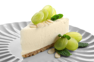 Delicious cheesecake slice with grapes on plate