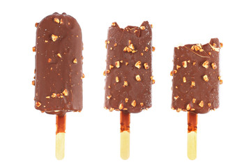 three chocolate ice cream sticks with almond and bite isolated on white