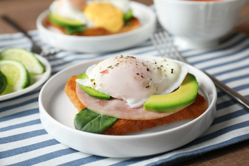 Plate with tasty egg Benedict on table