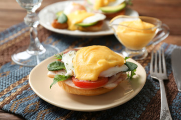 Plate with tasty egg Benedict on table