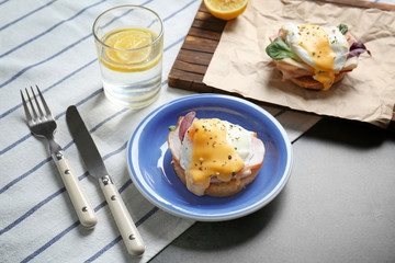 Breakfast with tasty eggs Benedict on table