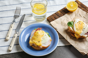 Breakfast with tasty eggs Benedict on table