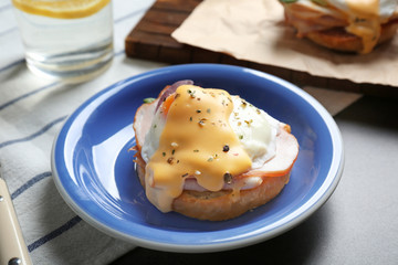 Breakfast with tasty eggs Benedict on table