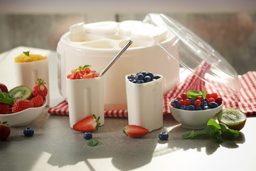 Composition with tasty homemade yogurt and ingredients on kitchen table