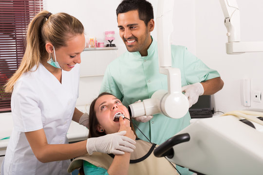 Dentist examines patient at clinic