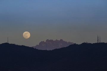 The magical moment and scenery during dusk with moon rising and mount kinabalu as a background from Kota Kinabalu.