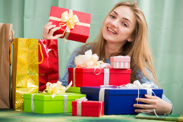 Portrait of girl with gifts and presents in domestic interior