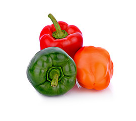 fresh green red and orange  bell pepper (capsicum) on a white background