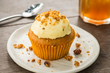 Carrot cupcake with cream cheese and hazelnuts