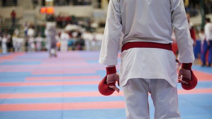 Sports teenagers - kid sportsmen at karate tatami - ready for fight