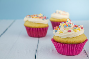 Cup cakes on blue table background