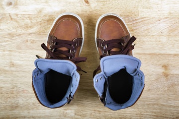 Pair of brown sneakers with laces