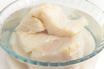 Cod Fish Fillet into a bowl in water