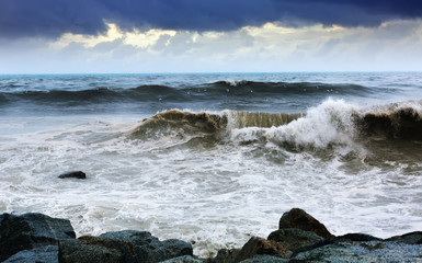 Sea wave near stones coast