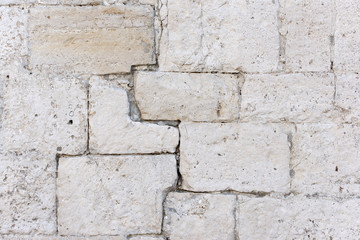 Detail of an antique white stone wall, background, texture