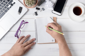 business hand man writing on blank notebook on table,