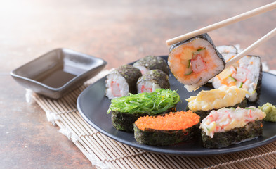 sushi on chopsticks, traditional japanese food