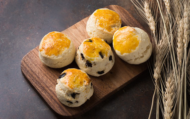 scones on wood block with barley, top view