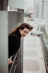 Young businesswoman standing with vintage and elegant dress outside. Lifestyle