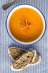 Carrot Soup Served in Bowl with Bread. Homemade Cream Carrot and Potato Pottage.