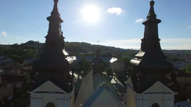 AERIAL flight away from ancient church in Lviv. 4K