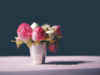 Bouquet of small roses on a dark background.