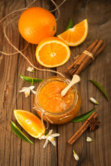 Fototapeta na wymiar Orange, orange jam on rustic wood background