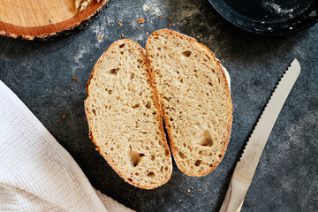 Section of homemade loaf of bread on a gray background. Selective focus