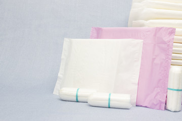 Heap of menstruation sanitary soft pads and cotton tampon for woman hygiene protection. Woman critical days, gynecological menstruation cycle. Medical conception