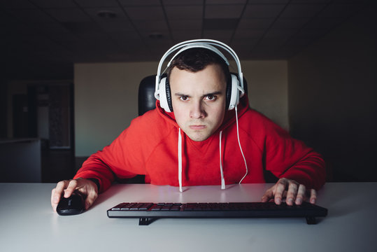 Portrait of funny gamer looking carefully monitor your computer and playing video games.