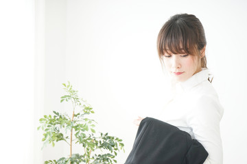 Woman putting off her jacket