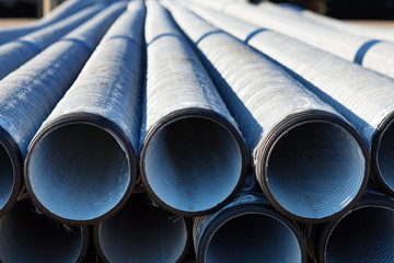 background of colorful grey plastic pipes used at the building site.