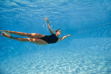Young female swimming underwater