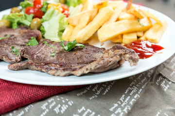 juicy steak beef meat with tomato and french fries