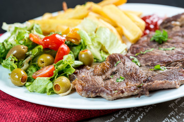juicy steak beef meat with tomato and french fries