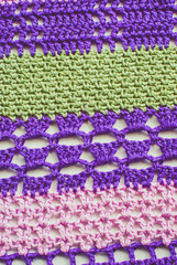 Colorful knitted background. Closeup of crochet blanket