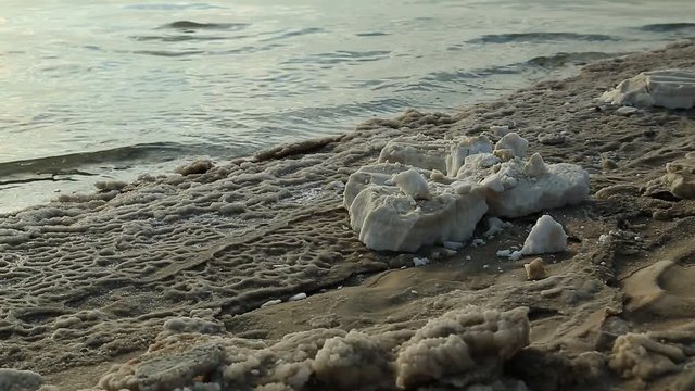 On the shore of Dead Sea, Jordan. White salt deposits of Dead Sea. Salt on the shore of Dead Sea in Hashemite Kingdom of Jordan
