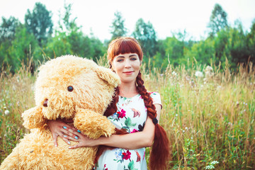 woman with a Teddy bear in nature