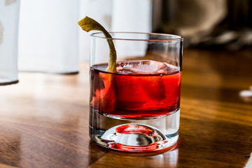 Negroni Cocktail with lemon peel and ice