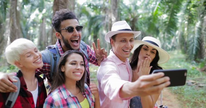 People Group Taking Selfie Photo On Cell Smart Phone On Hike, Men And Woman Trekking In Tropical Palm Tree Forest Slow Motion 60