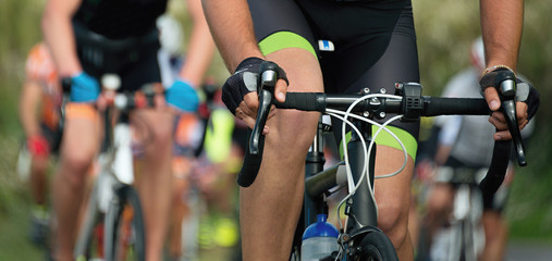 Cycling competition cyclist athletes riding a race on the road
