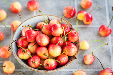 Bowl of fresh wet pink cherry