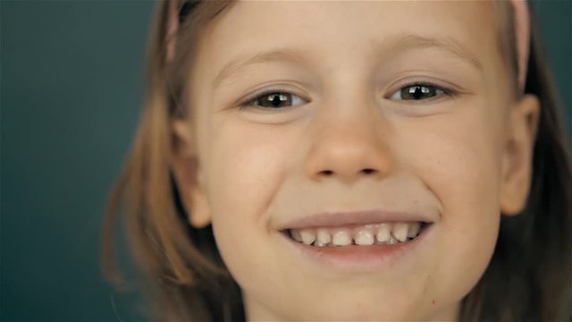 Portrait of a beautiful liitle girl close-up, smiling kid child