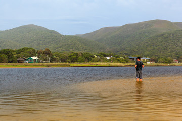 Fototapeta na wymiar Flyfishing in the lagoon at Natures Valley, South Africa.
